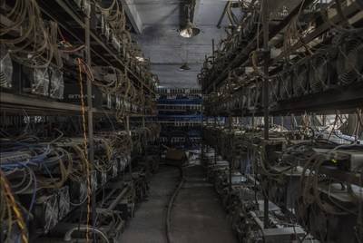 A mining farm filled with rows of mining machines, showcasing the scale and infrastructure required for efficient crypto mining.